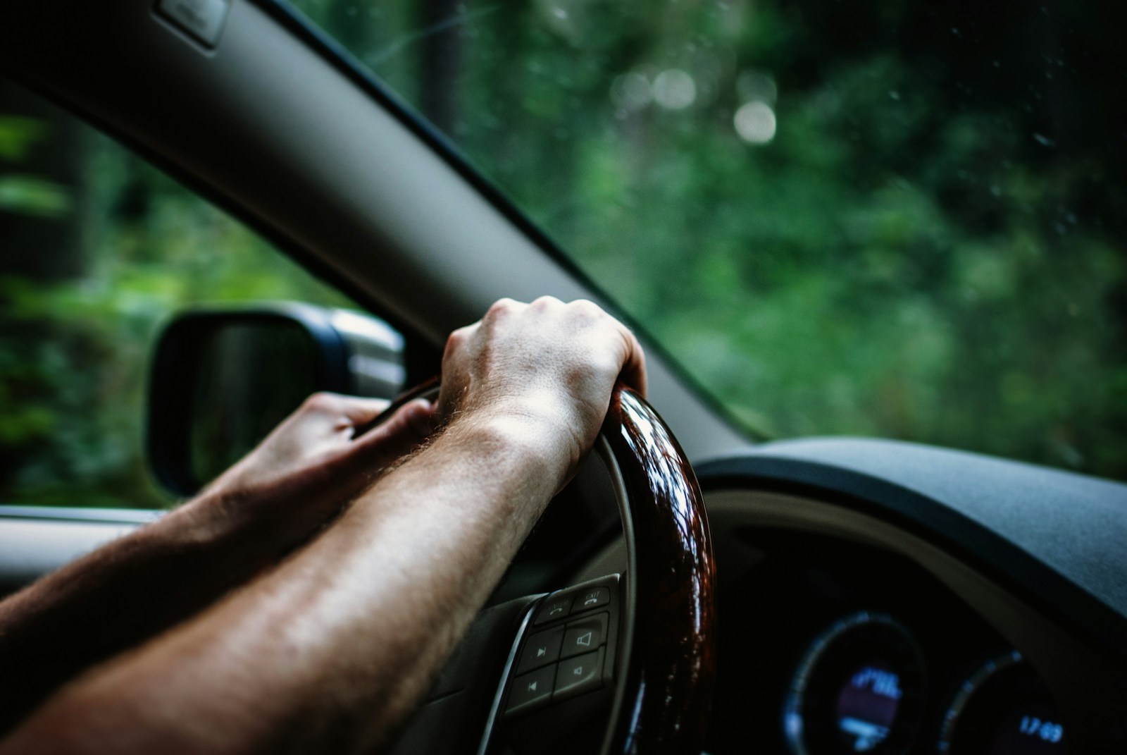 person holding car, with auto insurance deductibles, steering wheel