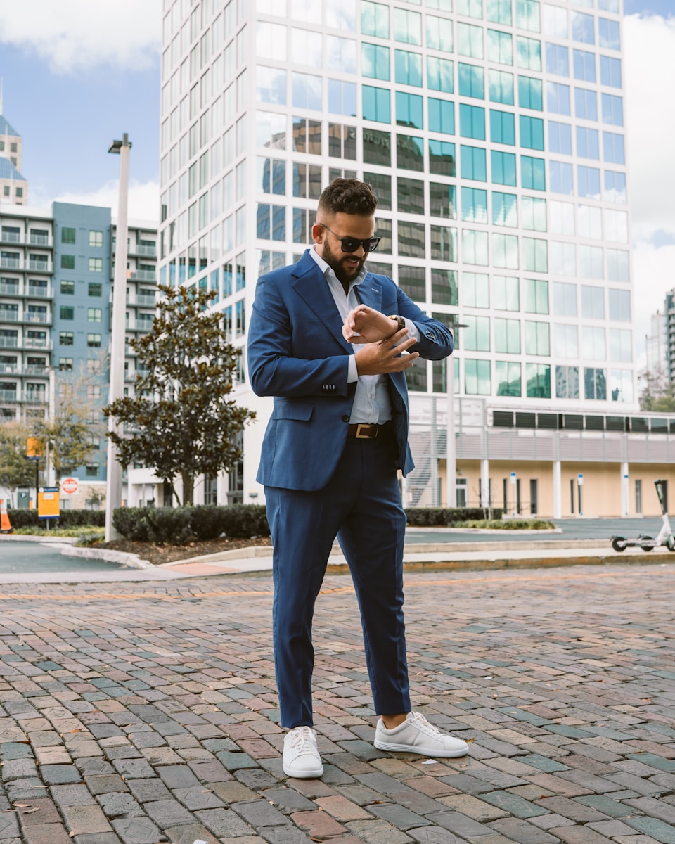 a man in a blue suit is looking at his cell phone searching for life insurance companies near him